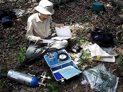Photo of a student with research instrumentation