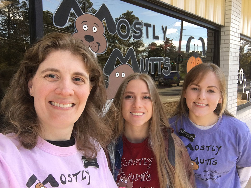 Dr. Martin and research assistants Lauren Faulkner and Christina Walthers are pictured in front of the Mostly Mutts facility