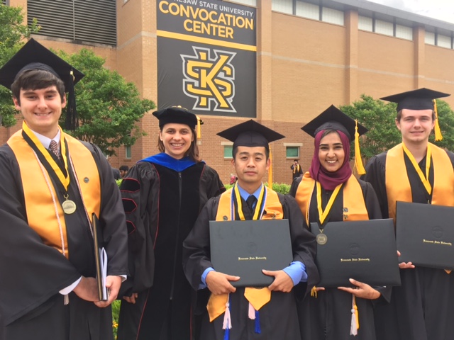 group photo of Daniela Tapu and students at KSU graduation