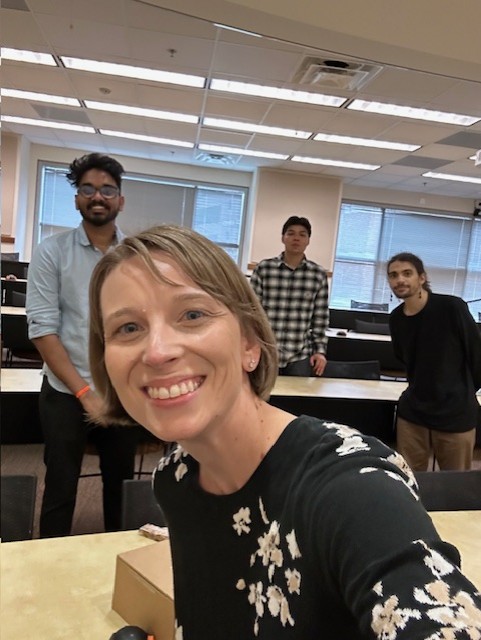 team members in a classroom smiling