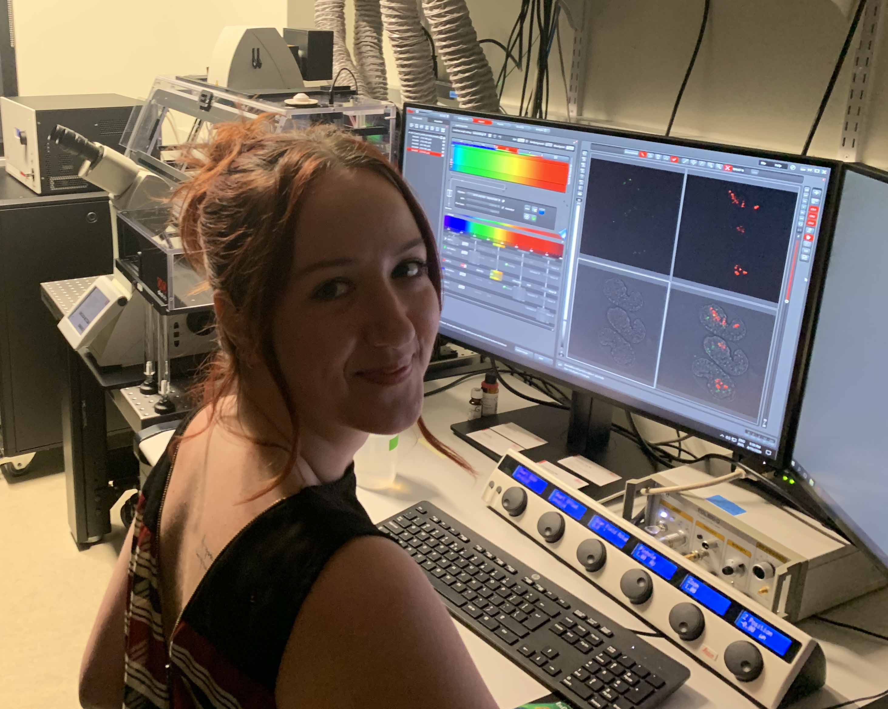 Photograph of a student using a confocal microscope