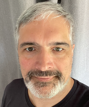 Man in his 50s with grey beard